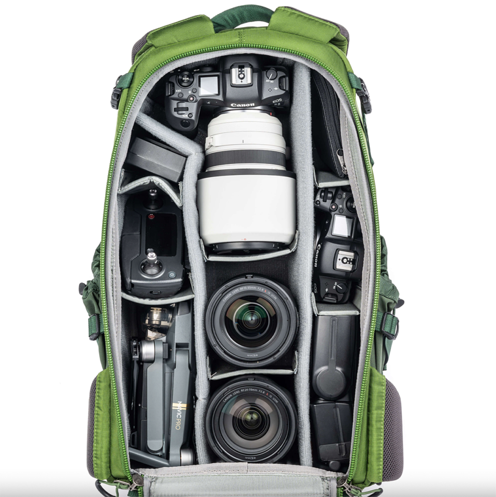 MindShift Gear Backlight 26L review showing the interior with Canon mirrorless cameras and lenses. A small DJI drone is also shown with its controller.
