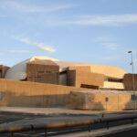 A Brutalist-style building photographed in early evening light.