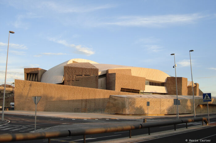 A Brutalist-style building photographed in early evening light.
