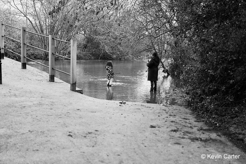 Mother and daughter wading in a river