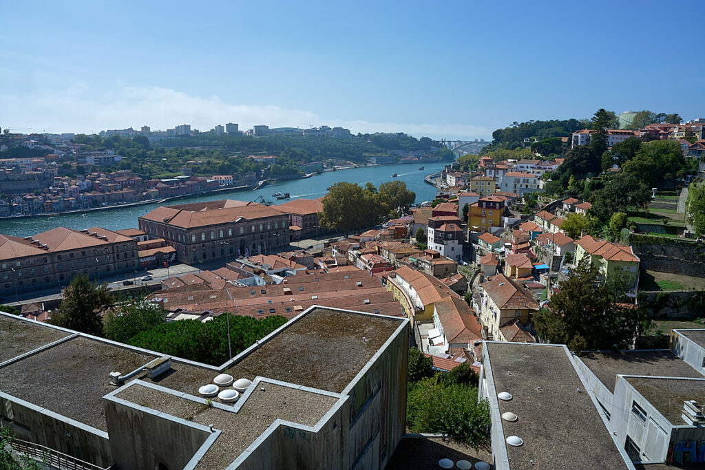 Looking down over a city by a river 