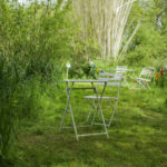 Table and chair beside a river